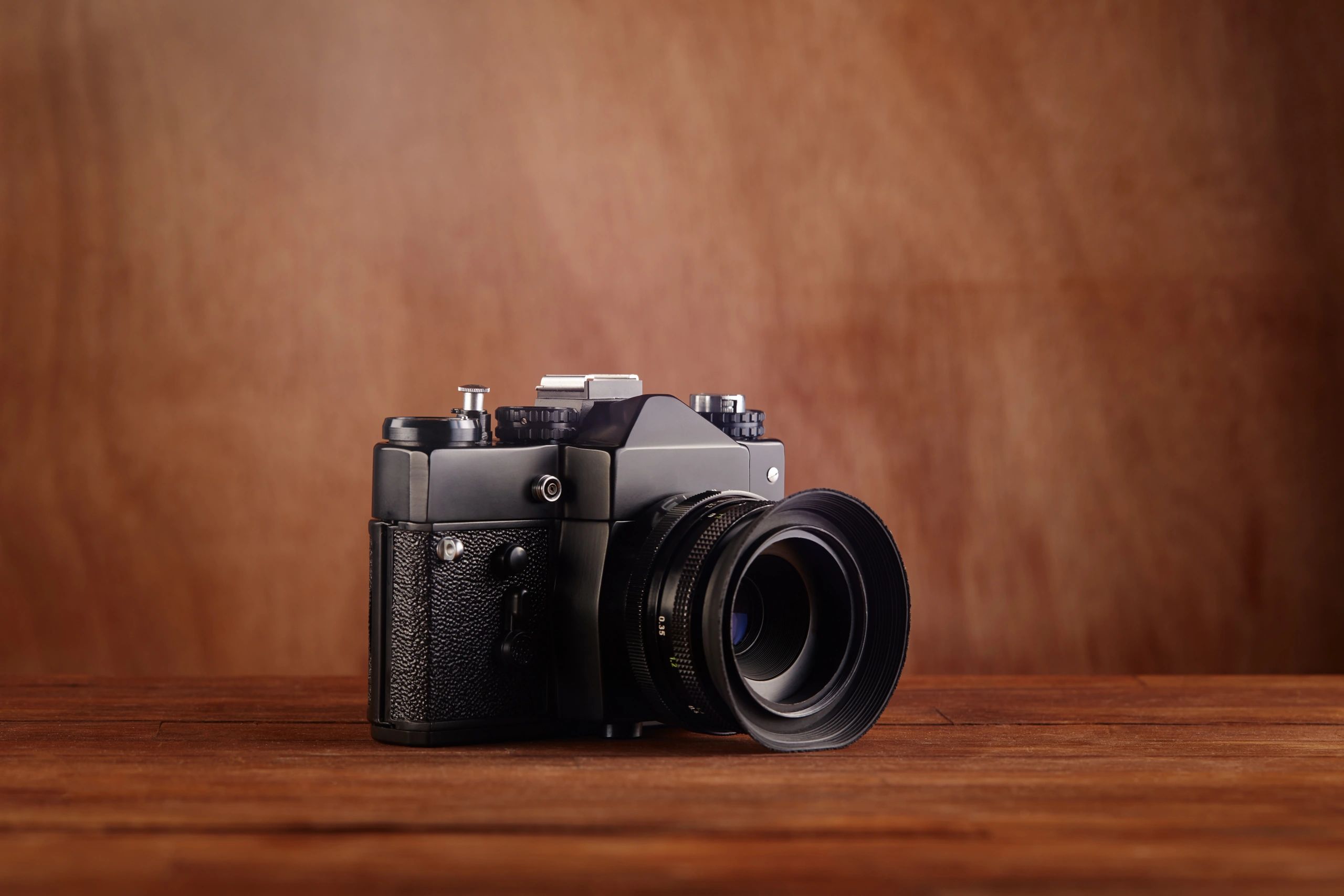 Vintage-style professional camera on a wooden table